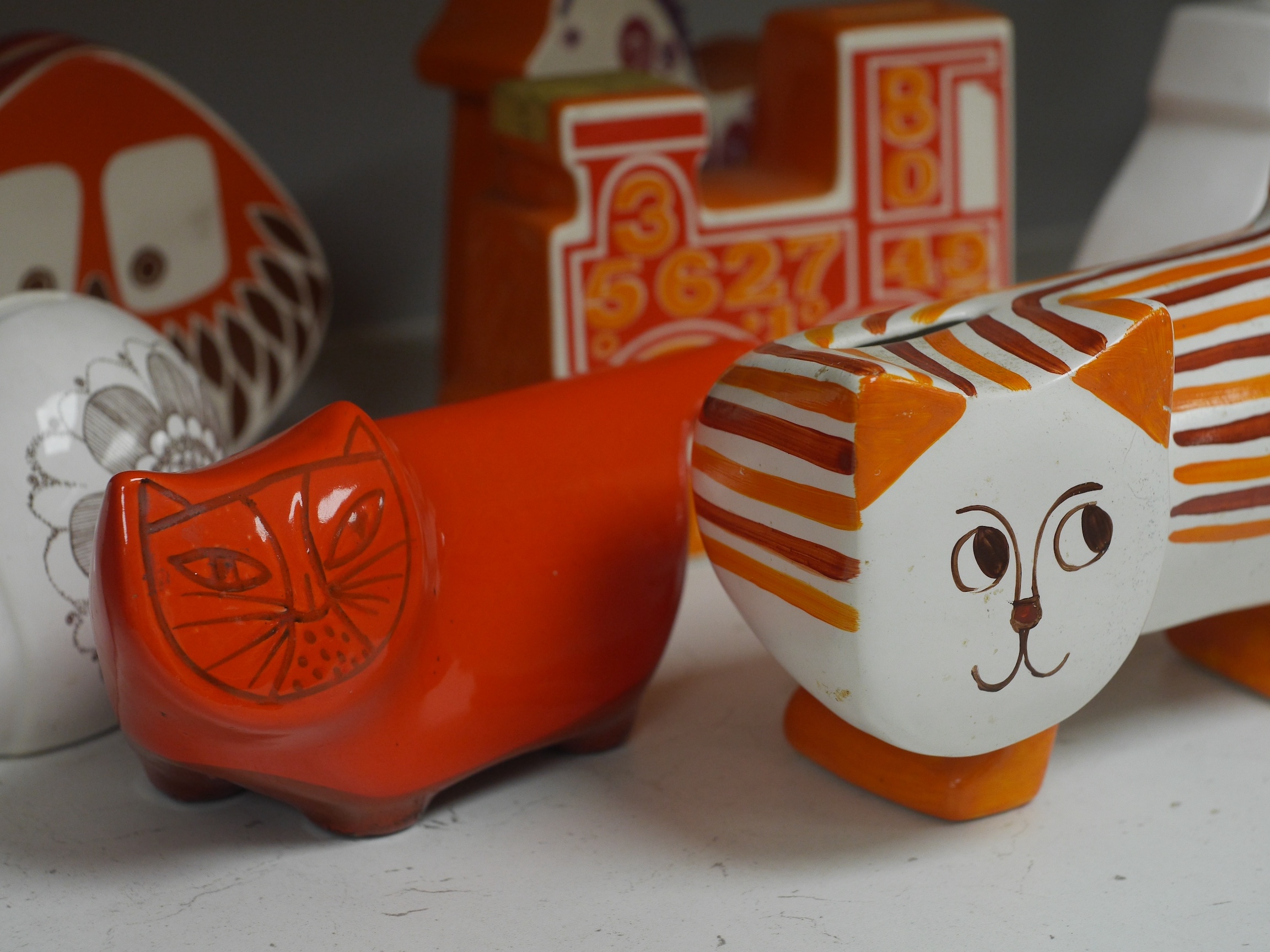 Seven mostly Carlton Ware 1960’s-1970’s money boxes to include examples in the form of a snail, train and two cats, largest 20cm wide. Condition - mostly fair to good